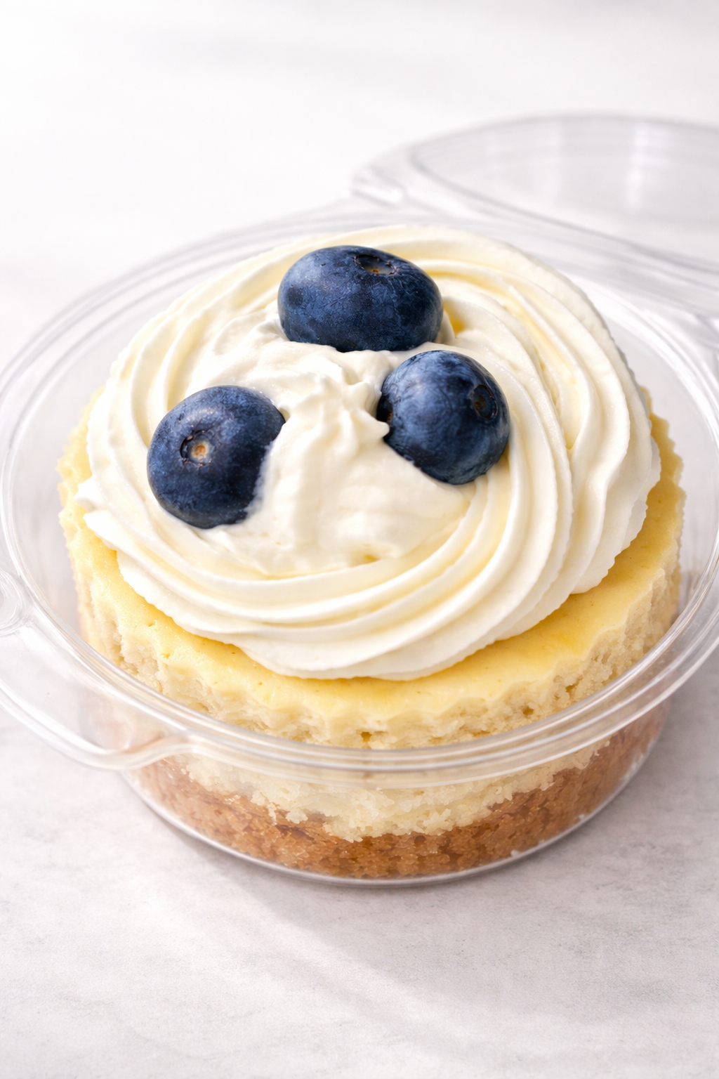Single blueberry mini cheesecake in a clear cup